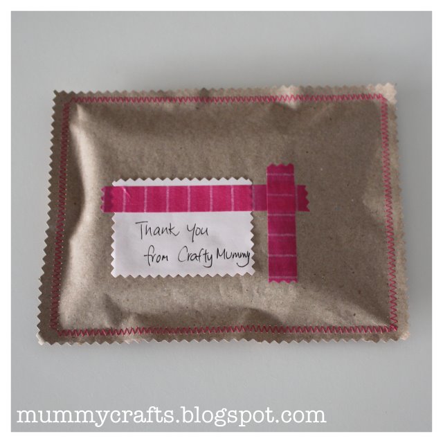 brown paper package pink stitching