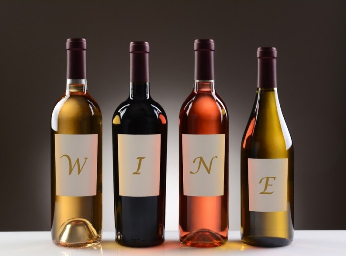 Four Wine Bottles with their labels spelling out the word WINE